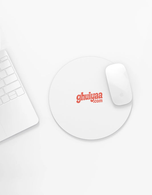 White circle mouse pad with Ghuiyaa.com logo on a minimal desk setup