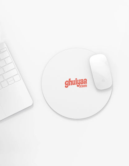 White circle mouse pad with Ghuiyaa.com logo on a minimal desk setup