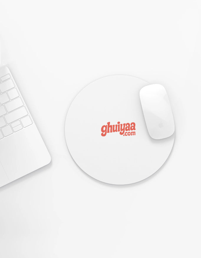 White circle mouse pad with Ghuiyaa.com logo on a minimal desk setup